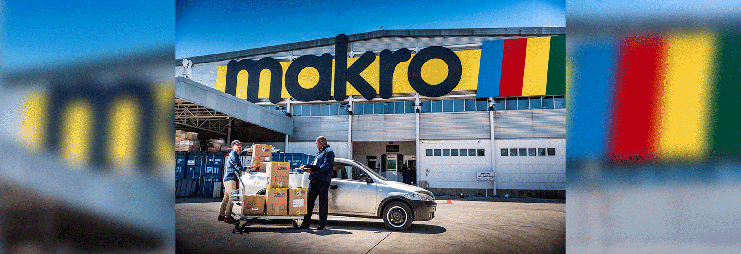 Exterior of a Makro store. An associate loas merchandise into a customer's car.